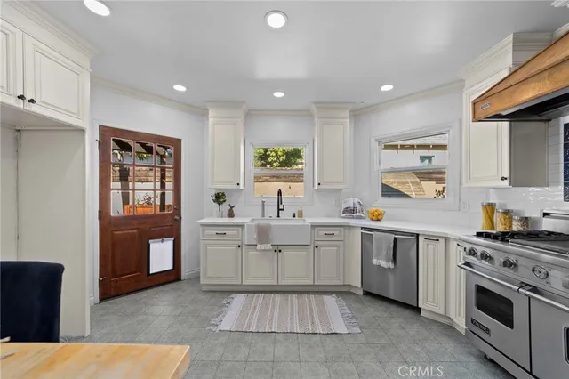 a kitchen with stainless steel appliances kitchen island granite countertop a table and chairs in it