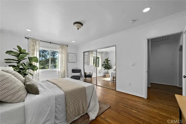 a spacious bedroom with a bed and a window