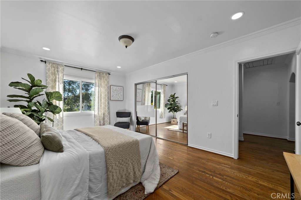 1697 Allen Avenue Pasadena, CA 91104 - Photo 23 of 58 a bedroom with a large bed and a potted plant