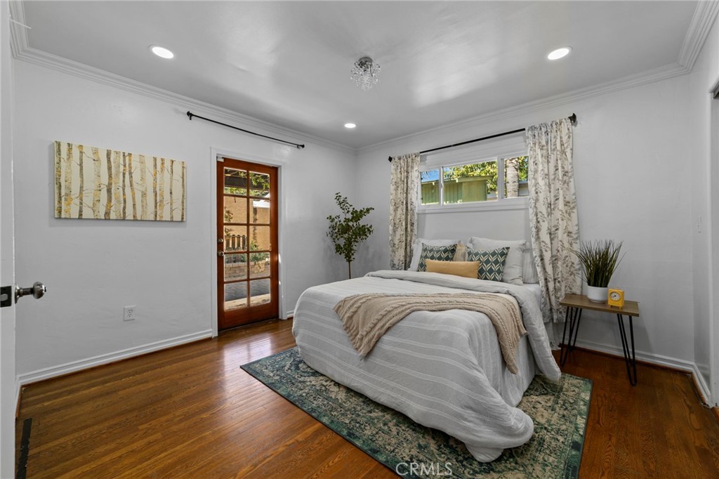 1697 Allen Avenue Pasadena, CA 91104 - Photo 28 of 58 a spacious bedroom with a large bed and a wooden floor