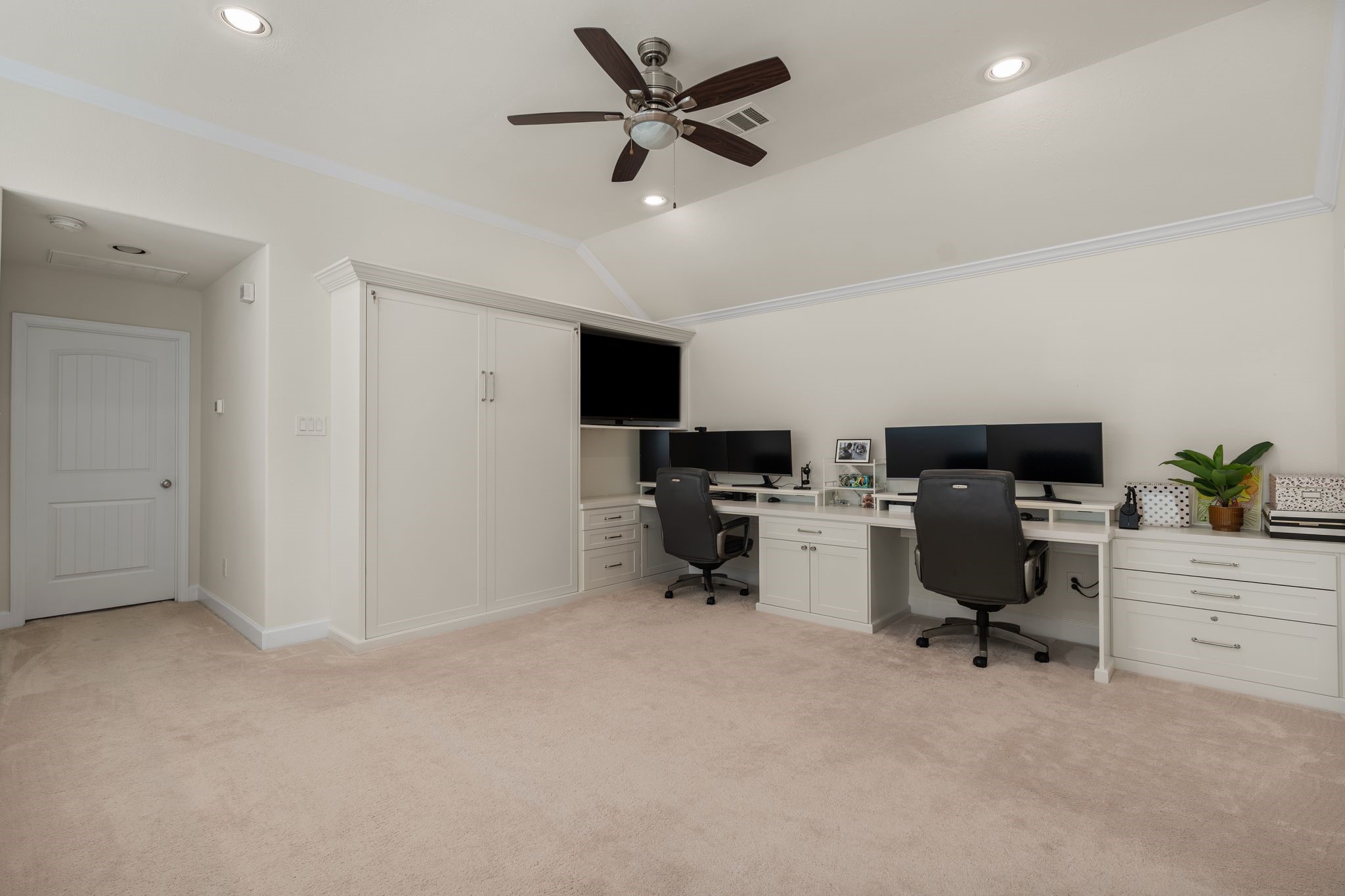 5230 Darling Street Houston, TX 77007 - Photo 18 of 34 The custom built-in desks make working from home a reality. Or could be a perfect place for homework! The door to the left is the Primary Suite.