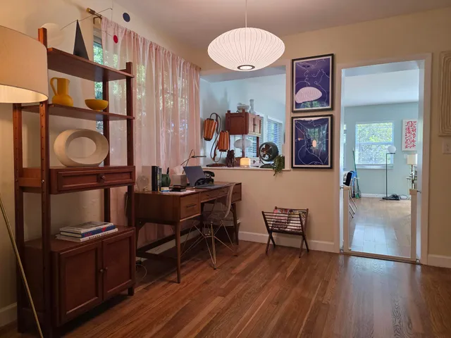 a living room with furniture and a wooden floor