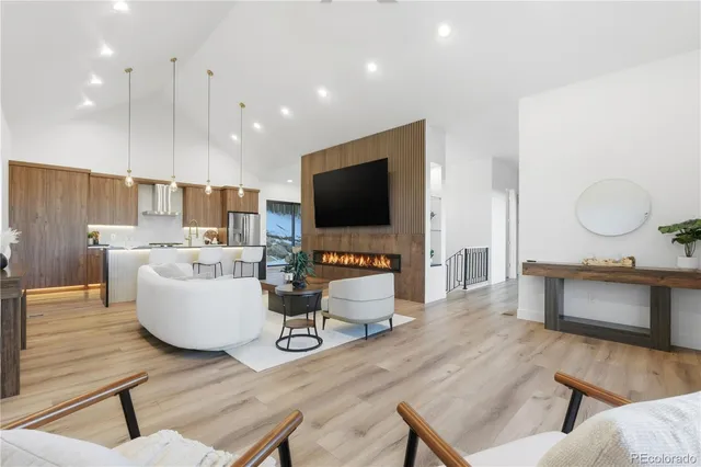 a living room with fireplace furniture and a flat screen tv
