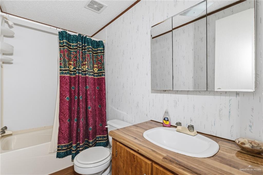 215 South Valley View Road, Unit 15&16 Donna, TX 78537 - Photo 12 of 13 a bathroom with a sink toilet and shower