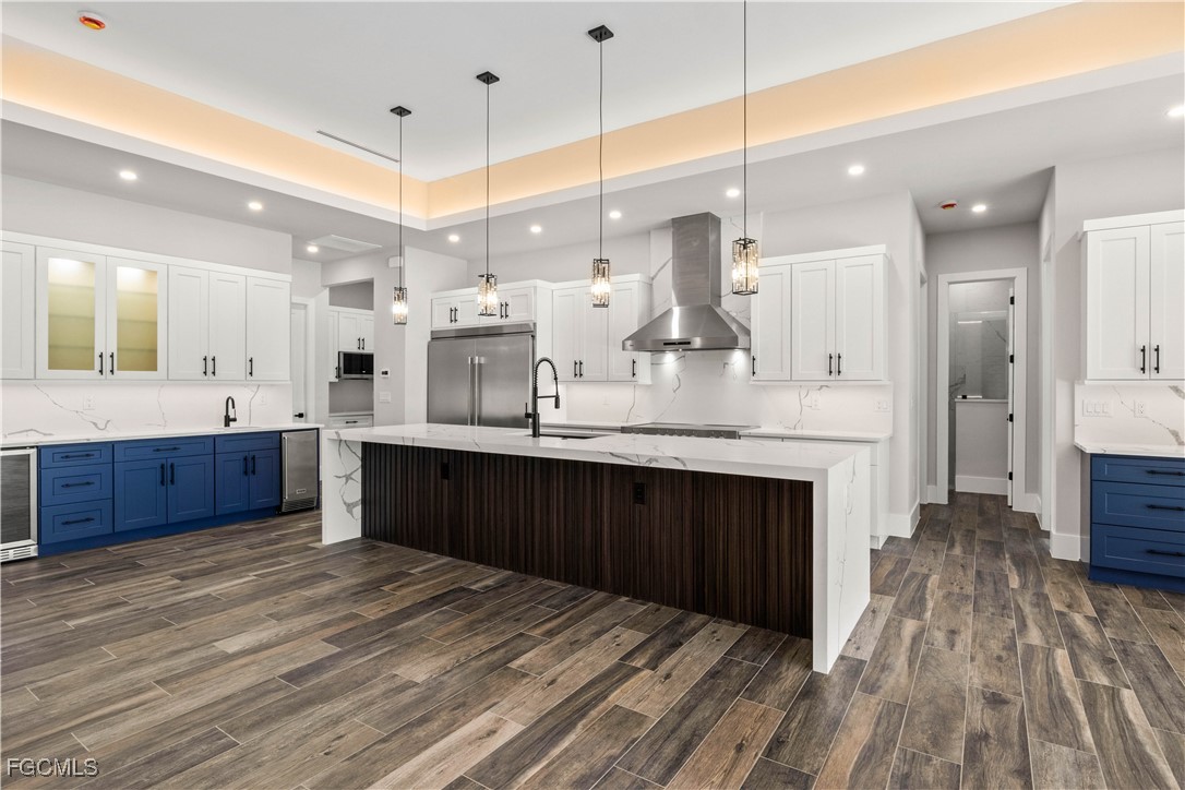 3906 Southwest 6th Terrace Cape Coral, FL 33991 - Photo 15 of 50 a large kitchen with stainless steel appliances kitchen island granite countertop a sink counter space and cabinets