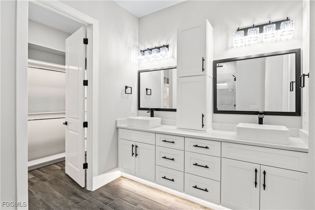 3906 Southwest 6th Terrace Cape Coral, FL 33991 - Photo 25 of 50 a bathroom with a double vanity sink mirror and