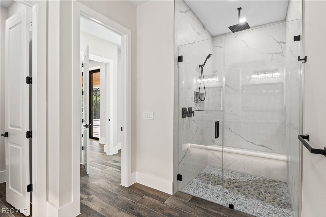 3906 Southwest 6th Terrace Cape Coral, FL 33991 - Photo 26 of 50 a bathroom with a glass shower door