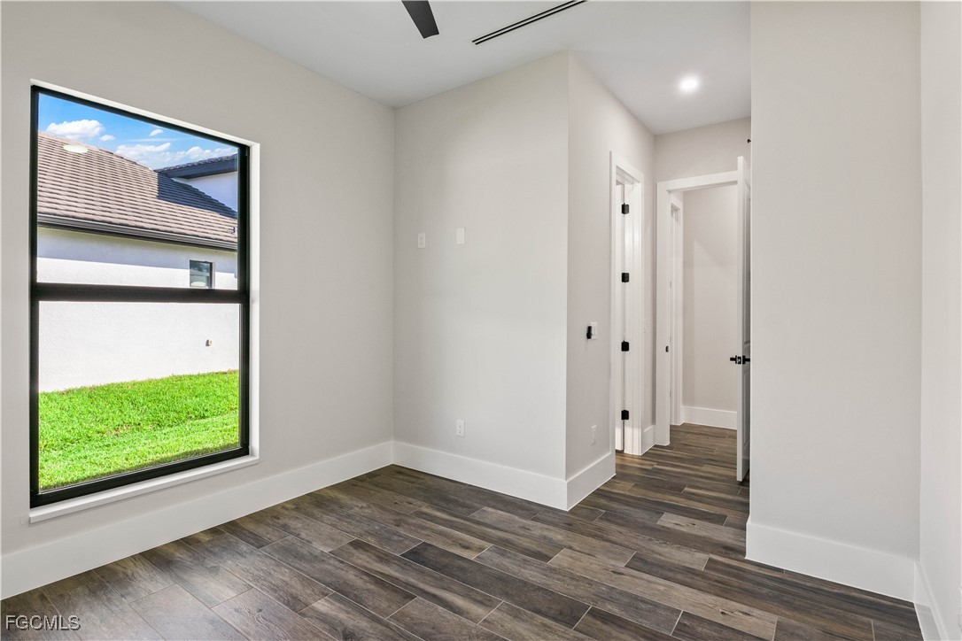 3906 Southwest 6th Terrace Cape Coral, FL 33991 - Photo 28 of 50 a view of an empty room with wooden floor and a window