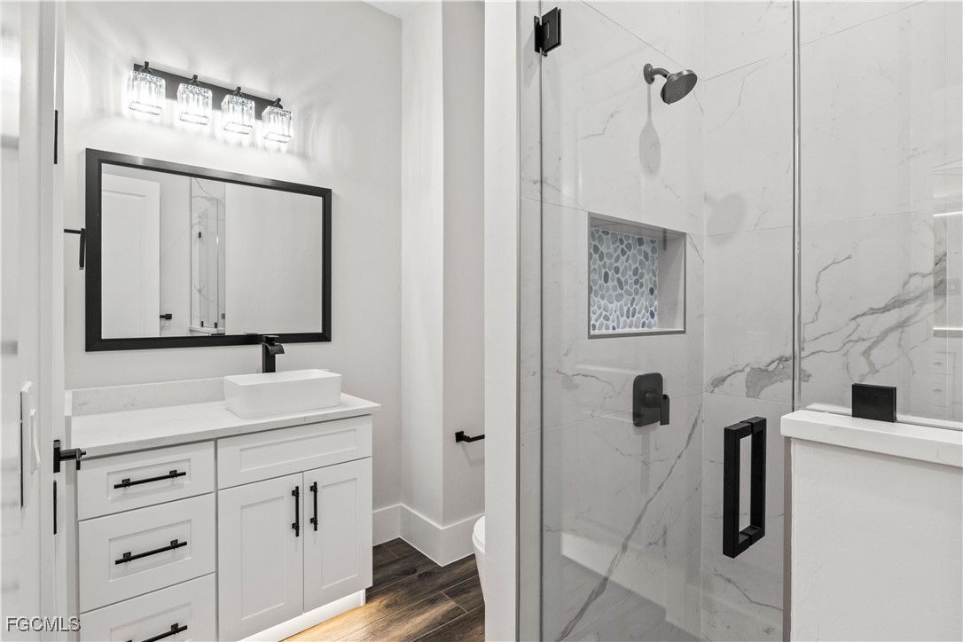 3906 Southwest 6th Terrace Cape Coral, FL 33991 - Photo 29 of 50 a bathroom with a sink vanity and a mirror