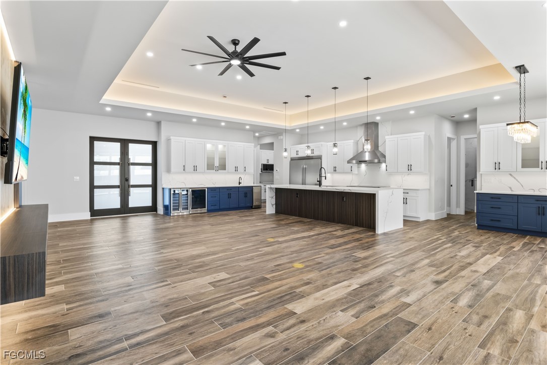 3906 Southwest 6th Terrace Cape Coral, FL 33991 - Photo 9 of 50 a view of a living room a kitchen and a wooden floor