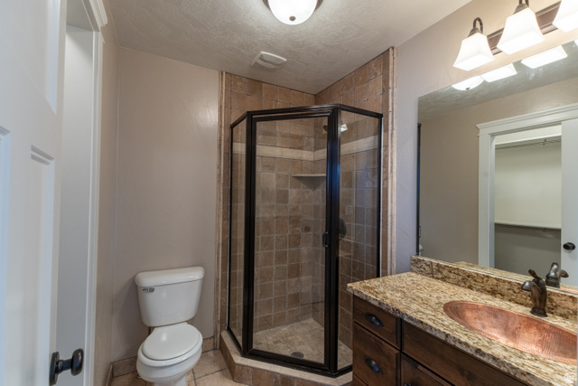 3565 West 1350th Street North Vernal, UT 84078 - Photo 25 of 54 Bathroom featuring a corner shower with glass enclosure and tiled walls