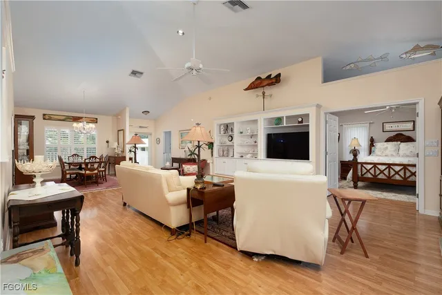 a kitchen with stainless steel appliances a stove a sink and white cabinets