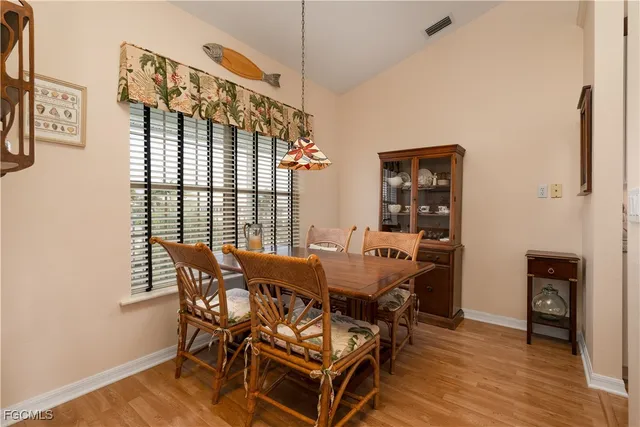 a kitchen with white cabinets and appliances