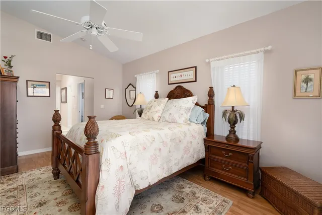 a bathroom with a granite countertop toilet a sink a mirror and a shower