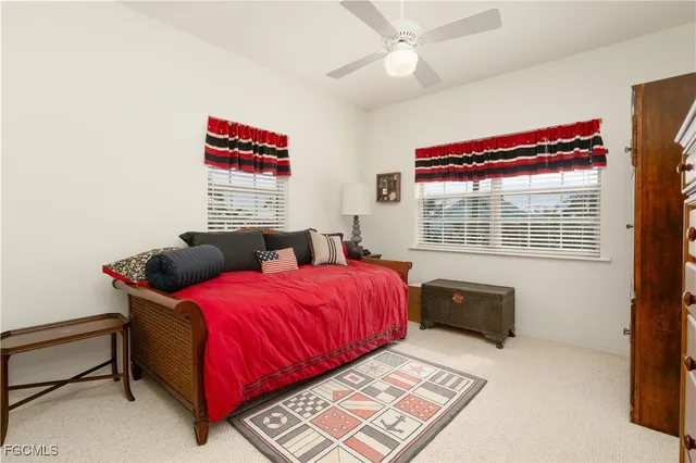 a bedroom with a bed dresser and a flat screen tv
