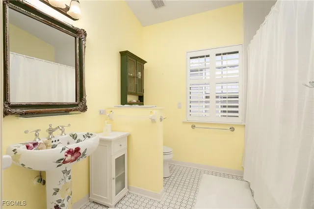 a dining room with furniture and a large window