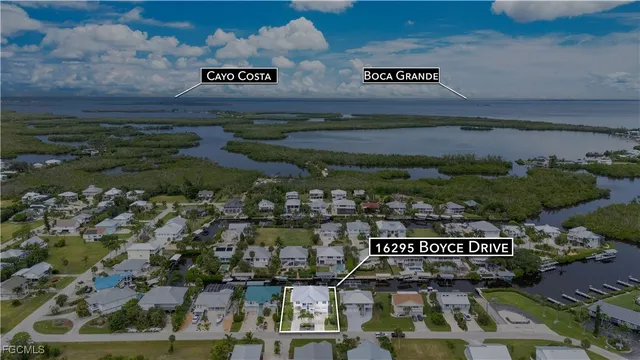 an aerial view of a houses with yard