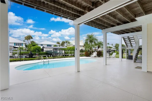 a view of a dining room with furniture a chandelier and wooden floor