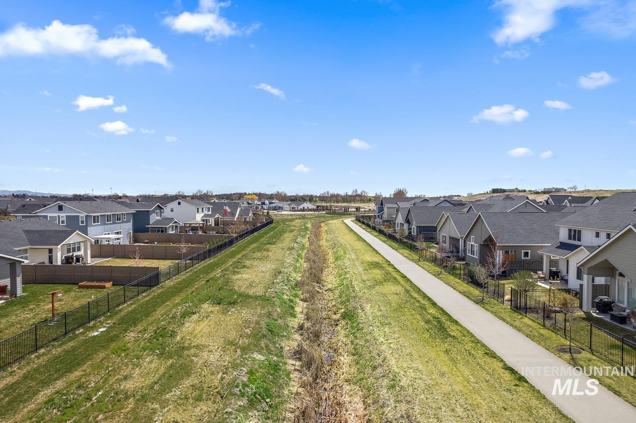 6216 South Wayland Way Meridian, ID 83642 - Photo 37 of 38 Residential neighborhood featuring a paved pathway, expansive grassy areas, and a variety of architectural styles