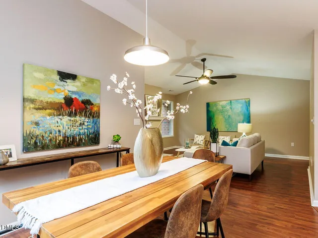 a dining room with furniture and wooden floor