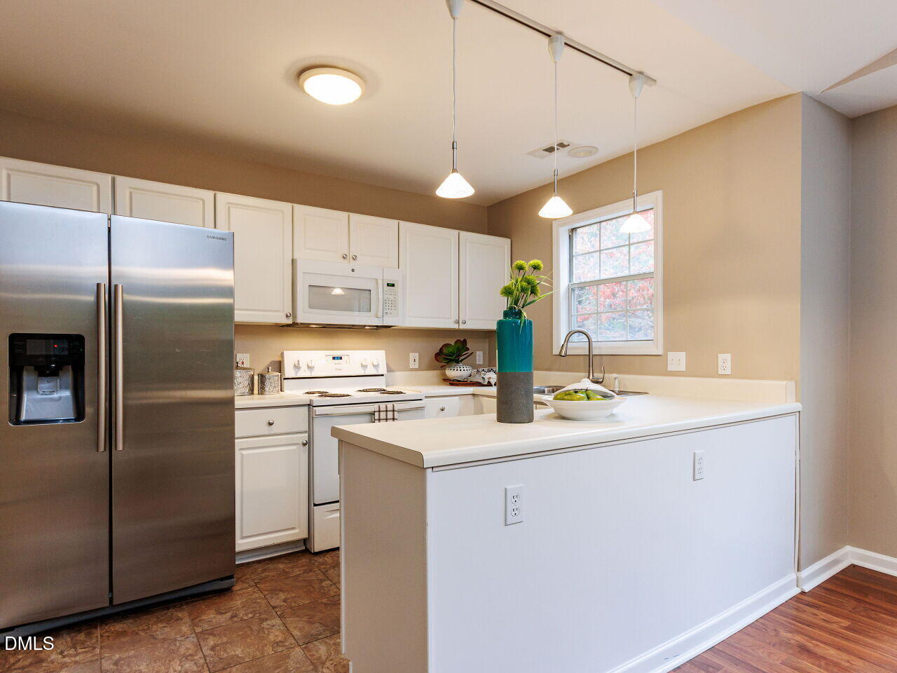 1221 Renshaw Court Cary, NC 27518 - Photo 12 of 29 a kitchen with a refrigerator a sink and cabinets