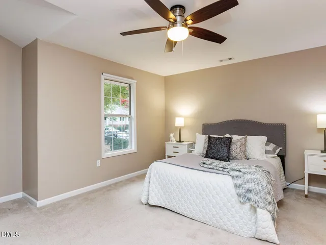 a bedroom with a large bed and a window