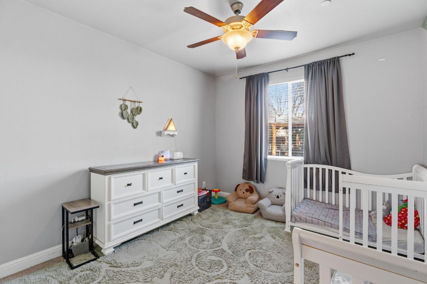 15717 West Botelho Avenue Kerman, CA 93630 - Photo 12 of 43 a bedroom with furniture and a window