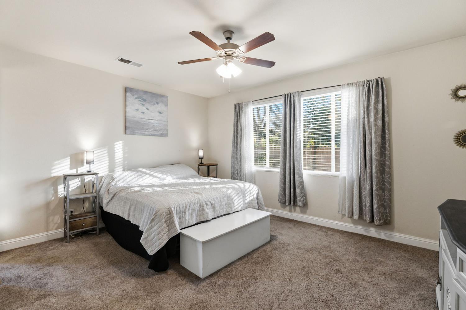 15717 West Botelho Avenue Kerman, CA 93630 - Photo 14 of 43 a spacious bedroom with a bed and window