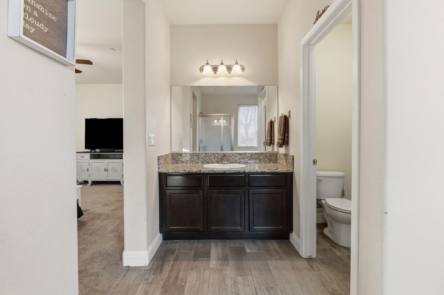 15717 West Botelho Avenue Kerman, CA 93630 - Photo 17 of 43 a bathroom with a double vanity sink and a mirror