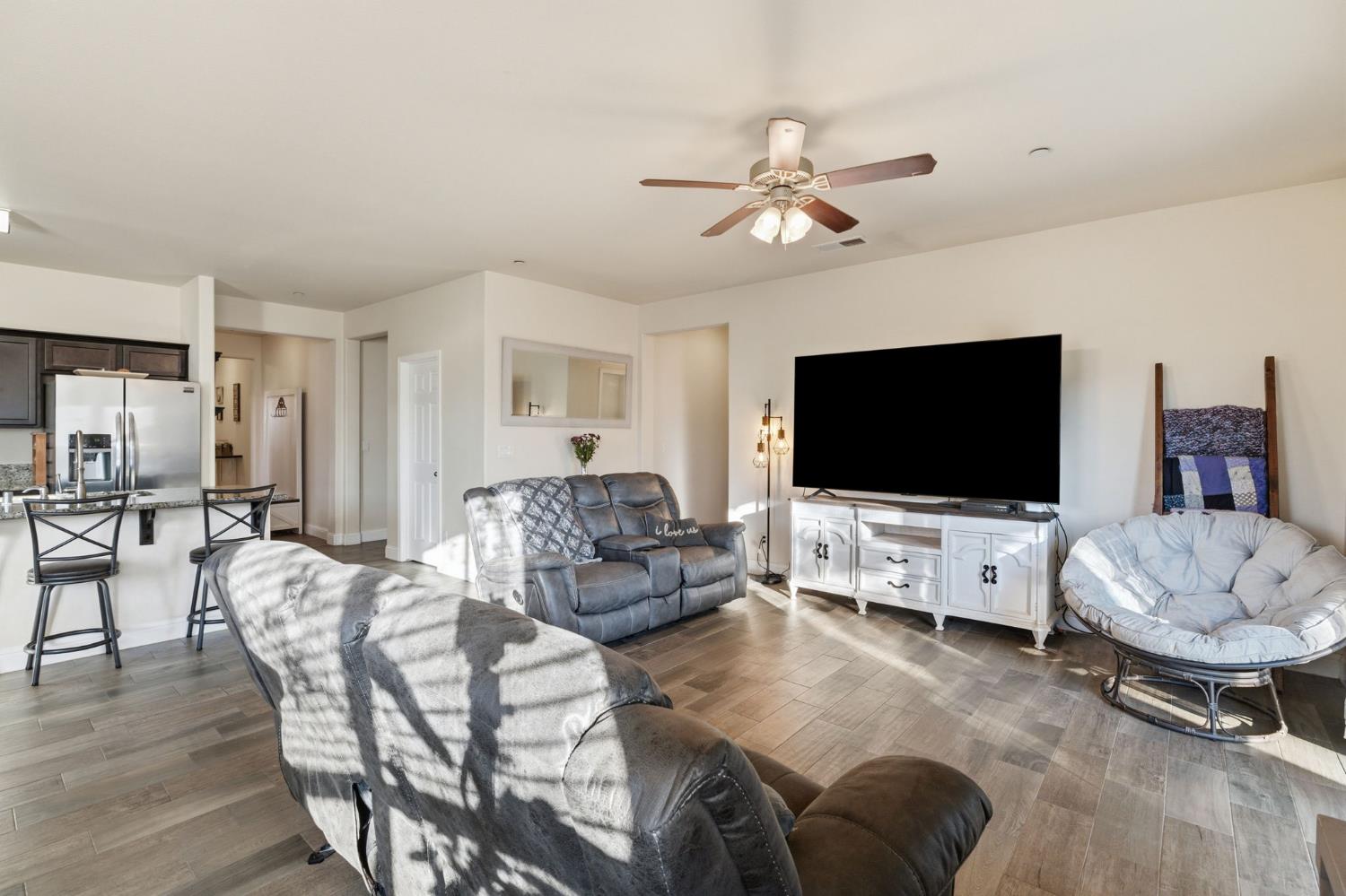 15717 West Botelho Avenue Kerman, CA 93630 - Photo 20 of 43 a living room with furniture and a flat screen tv