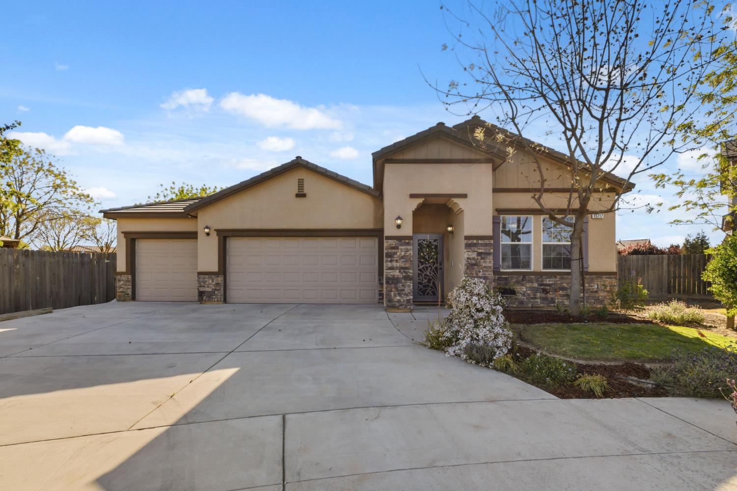 15717 West Botelho Avenue Kerman, CA 93630 - Photo 2 of 43 a front view of a house with garden