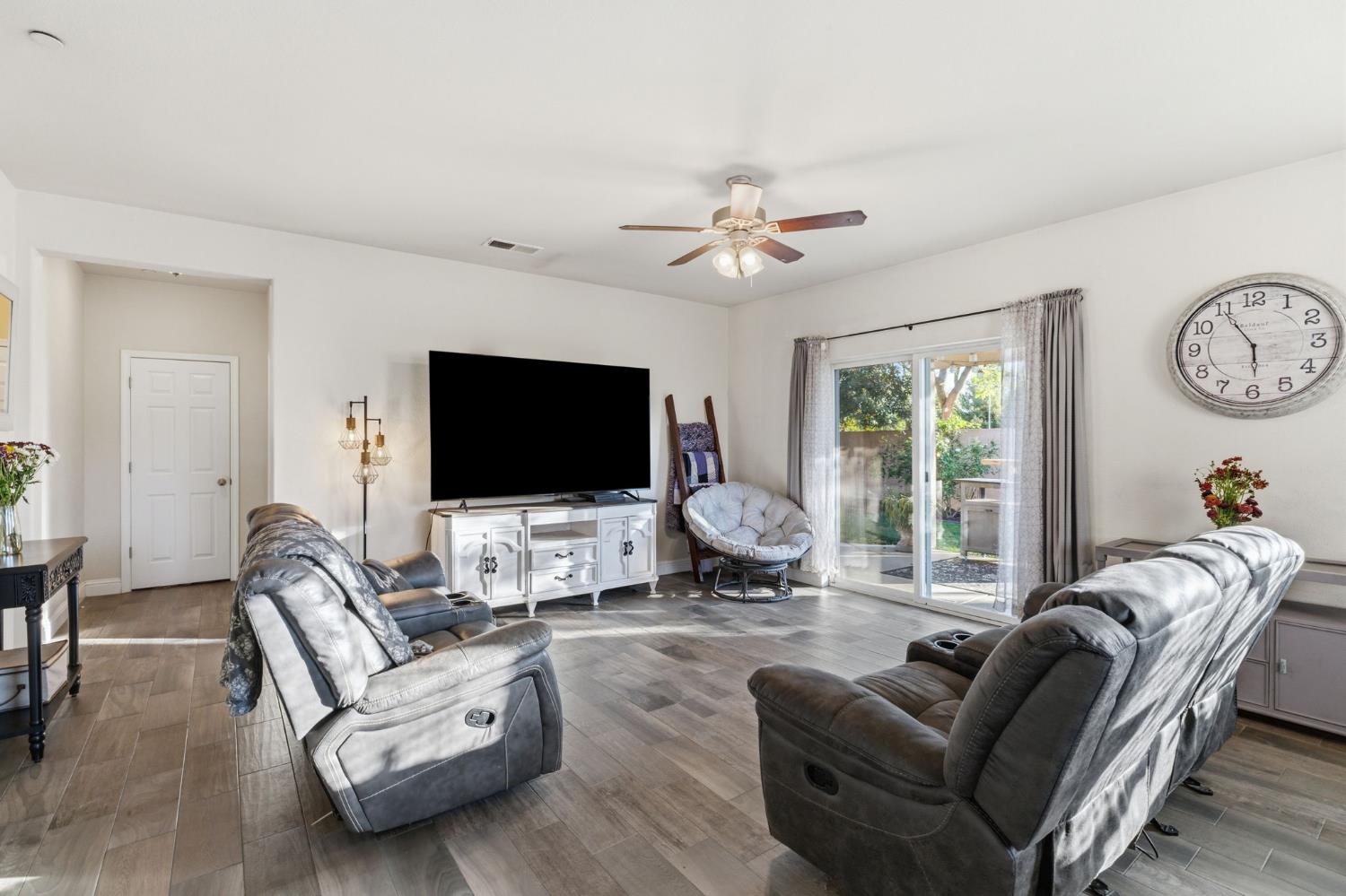 15717 West Botelho Avenue Kerman, CA 93630 - Photo 21 of 43 a living room with furniture a flat screen tv and a large window