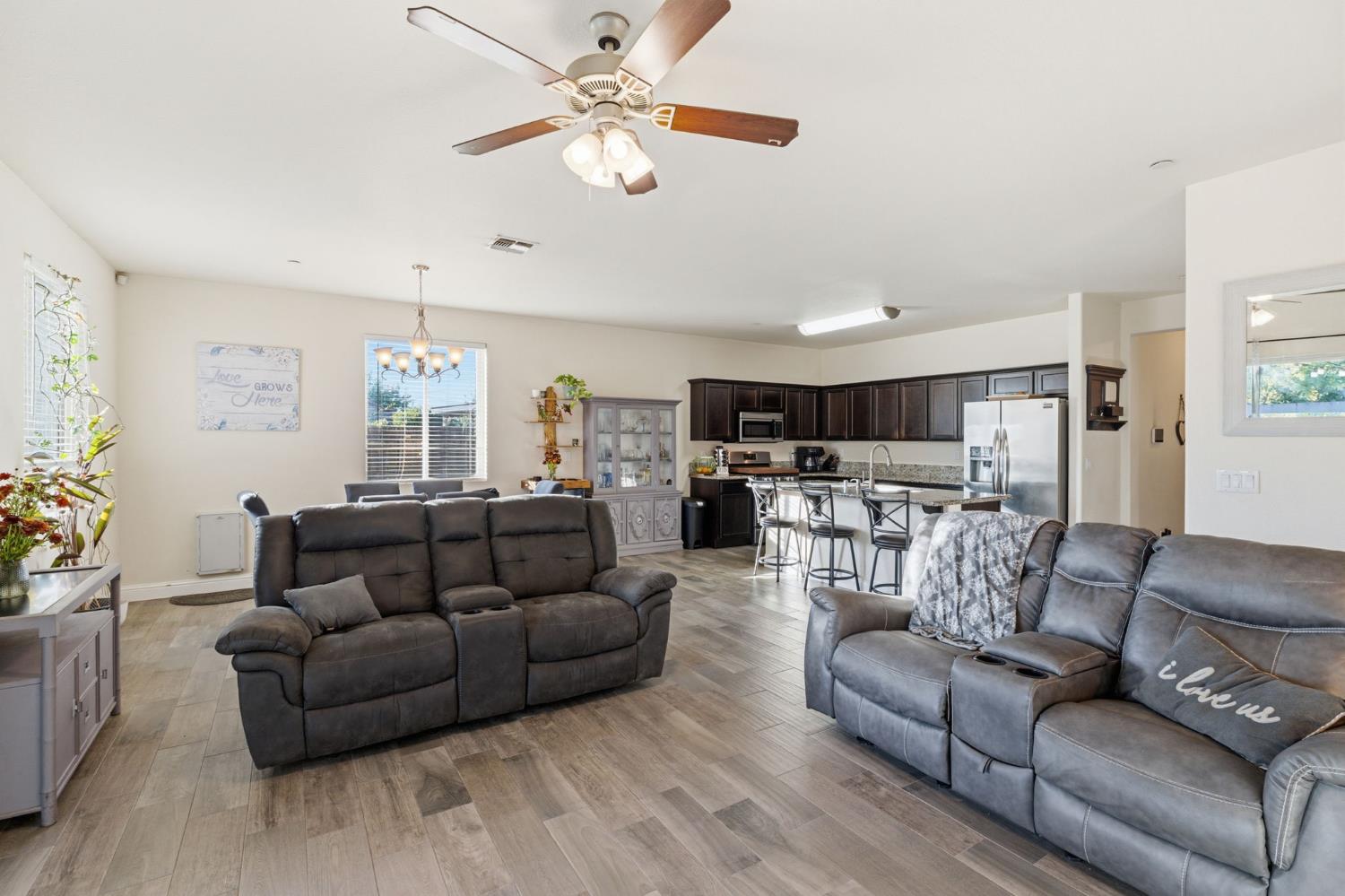 15717 West Botelho Avenue Kerman, CA 93630 - Photo 22 of 43 a living room with furniture kitchen view and a chandelier