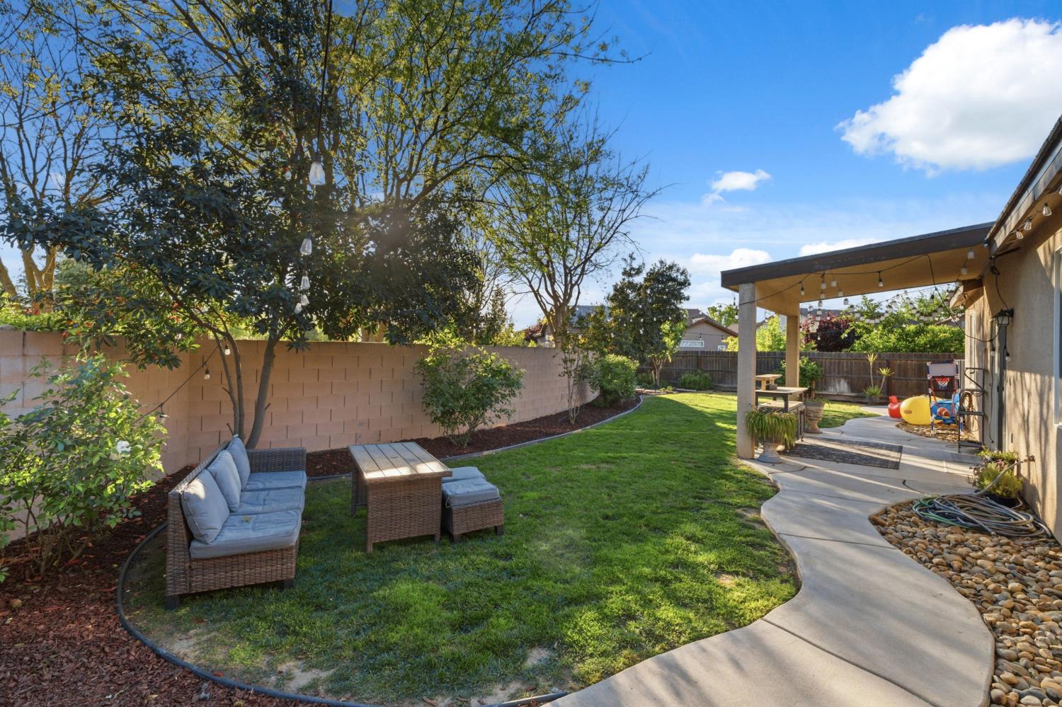 15717 West Botelho Avenue Kerman, CA 93630 - Photo 30 of 43 a view of a backyard with sitting area
