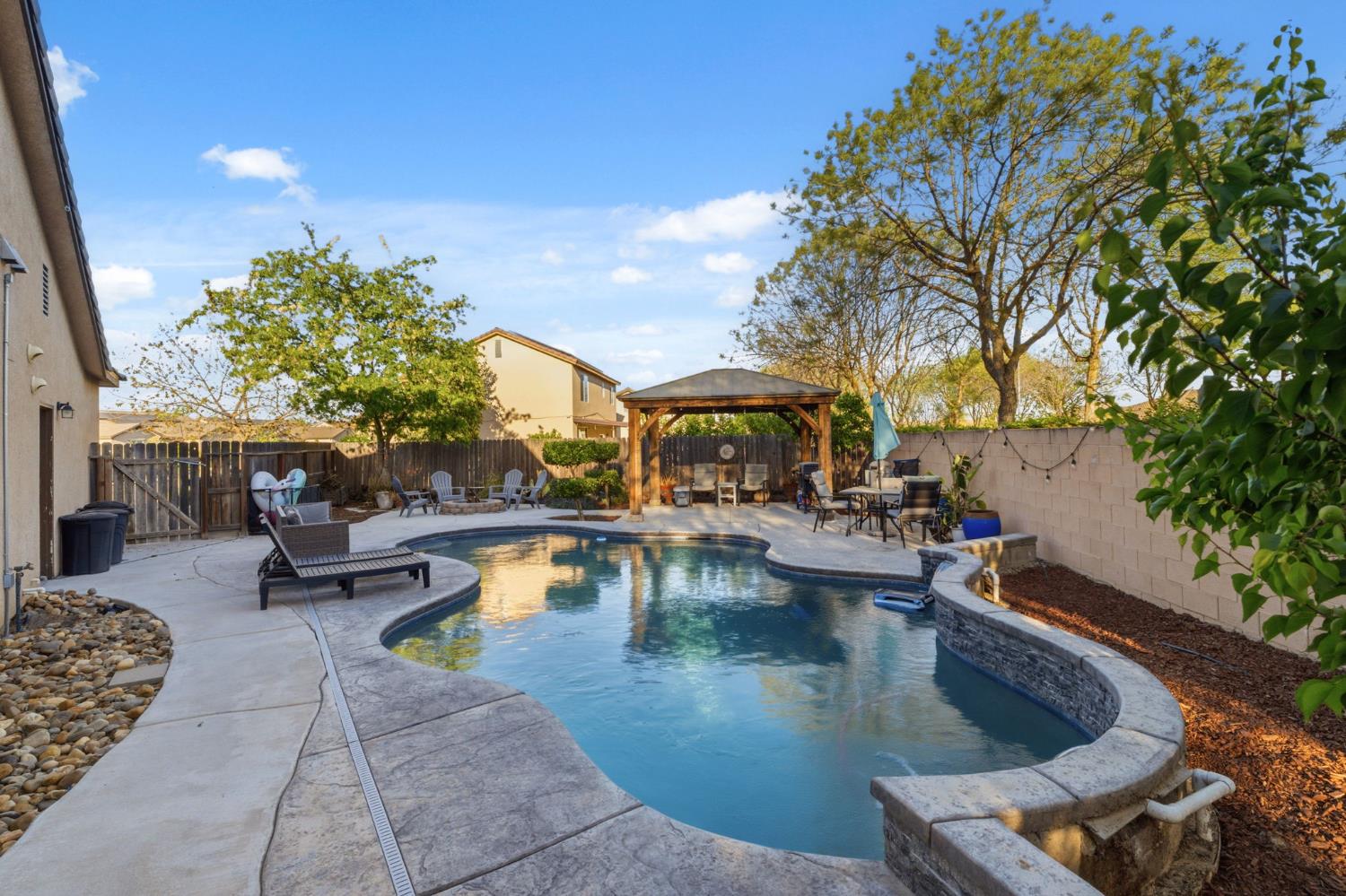 15717 West Botelho Avenue Kerman, CA 93630 - Photo 31 of 43 a view of swimming pool with outdoor seating and plants