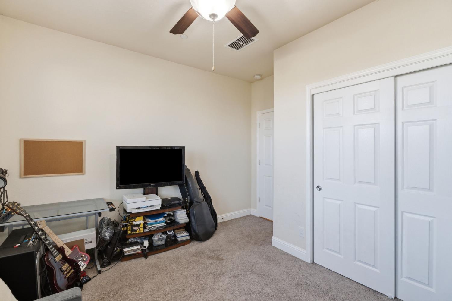 15717 West Botelho Avenue Kerman, CA 93630 - Photo 8 of 43 a view of a workspace with furniture and a window