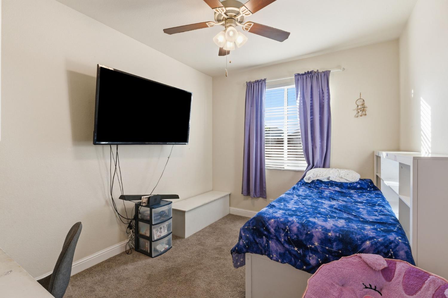 15717 West Botelho Avenue Kerman, CA 93630 - Photo 9 of 43 a bedroom with a bed and a flat screen tv