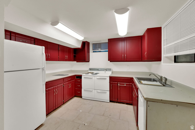 360 400 North Centerville, UT 84014 - Photo 28 of 30 Kitchen featuring red cabinetry, white countertops, white appliances, and a stainless steel sink
