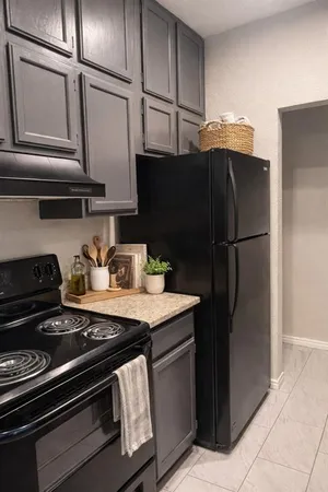 a kitchen with a refrigerator and a stove