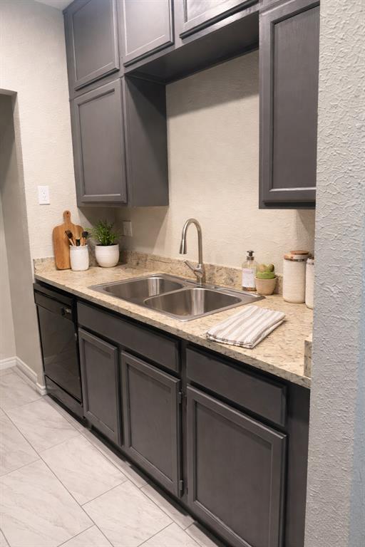5620 Live Oak Street, Unit 306 Dallas, TX 75206 - Photo 4 of 8 a kitchen with granite countertop a sink and cabinets
