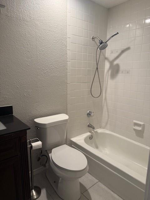 5620 Live Oak Street, Unit 306 Dallas, TX 75206 - Photo 6 of 8 a bathroom with a granite countertop toilet a sink and a shower