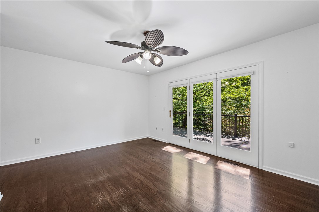 118 Beacon Ridge Circle Salem, SC 29676 - Photo 14 of 45 Hardwood floors and a ceiling fan enhance this inviting space, featuring sliding glass doors to the outdoor deck.