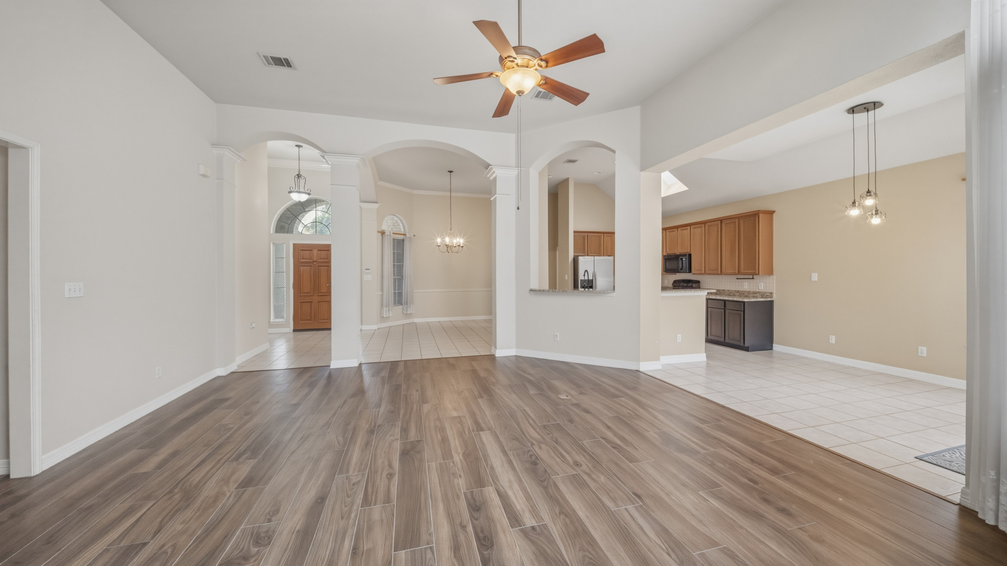 1108 Antelope Ridge Cedar Park, TX 78613 - Photo 26 of 27 An open floorplan living area showcases a beautiful wood-look tile floor and elegant archways.