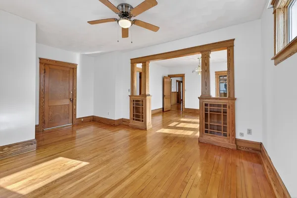 wooden floor in an empty room with a window