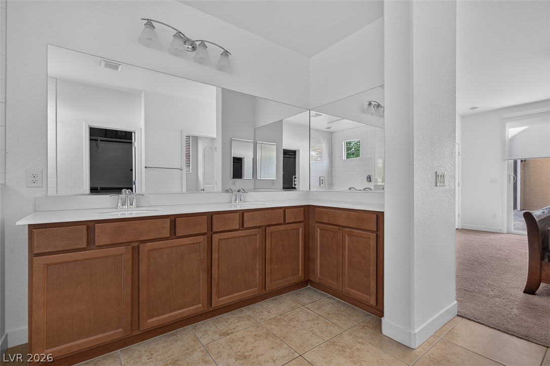 1100 East Sunset Road Henderson, NV 89011 - Photo 23 of 58 Double vanity with ample storage and bright lighting offers everyday convenience.