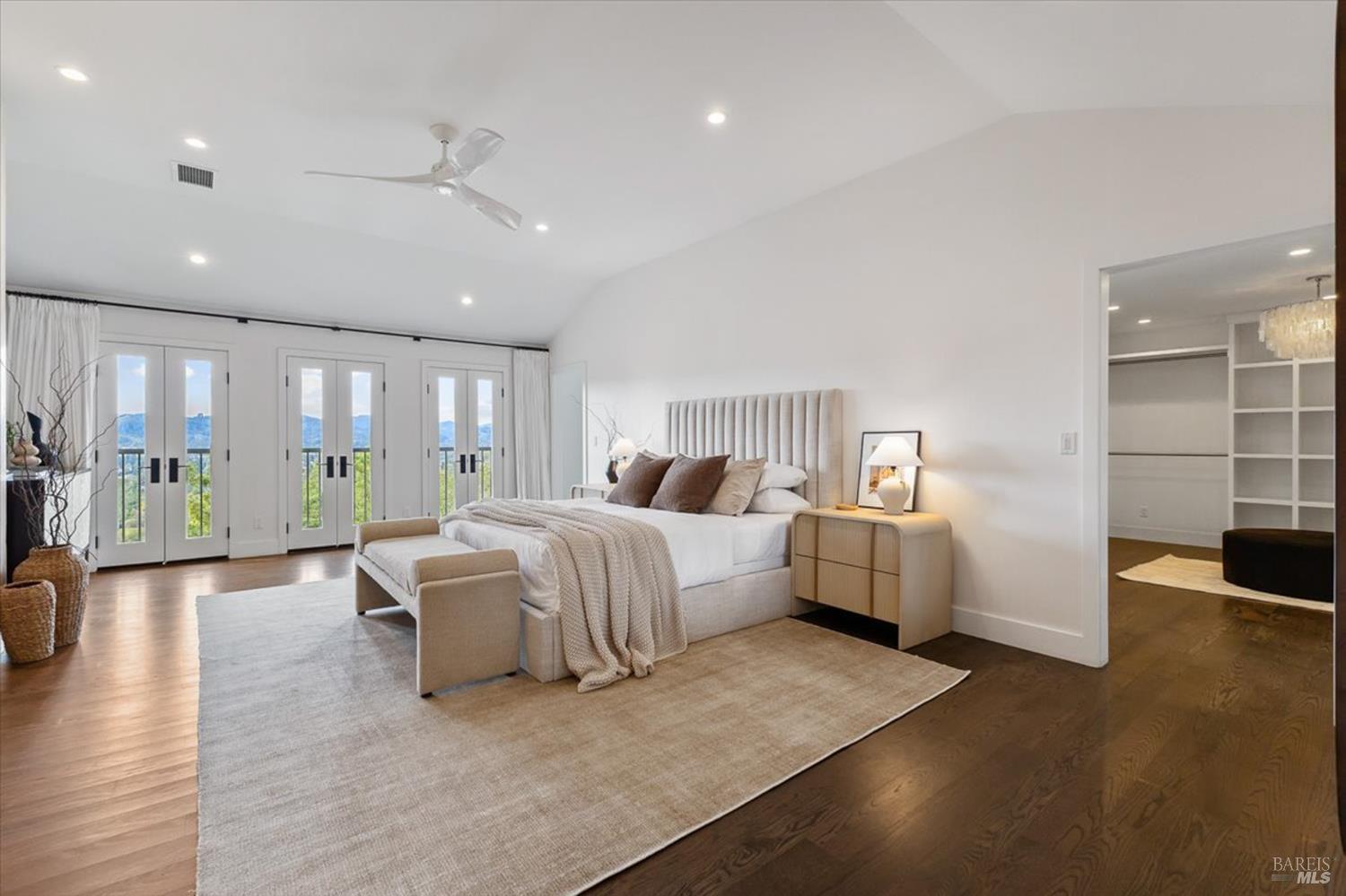 775 Benjamin Way Healdsburg, CA 95448 - Photo 24 of 96 a spacious bedroom with a large bed and a wooden floor