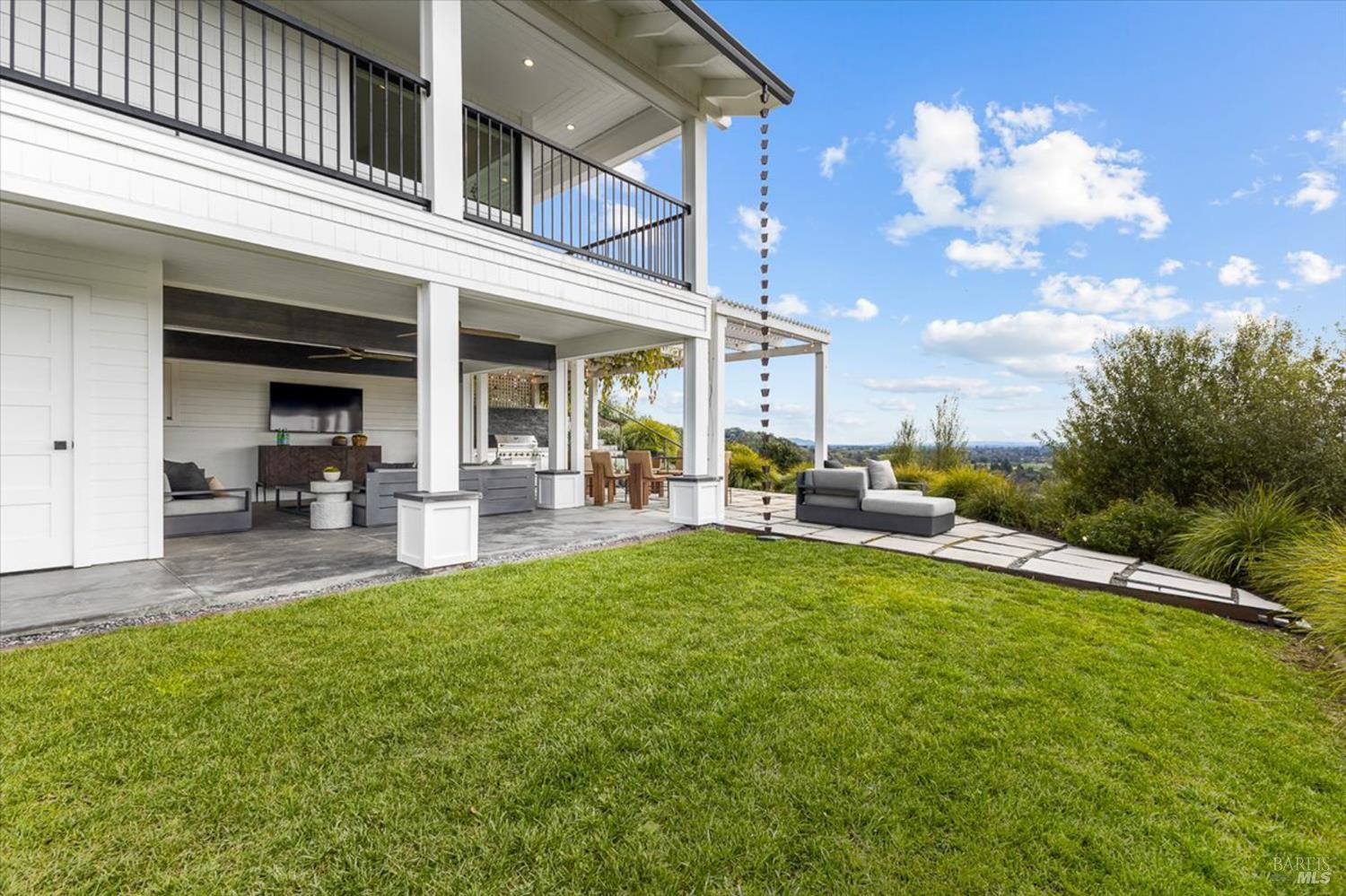 775 Benjamin Way Healdsburg, CA 95448 - Photo 59 of 96 a view of a patio with couches and a table and chairs with plants and wooden fence