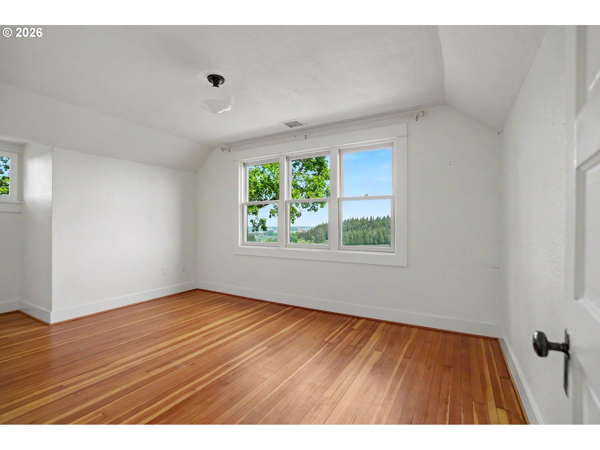 17135 Herigstad Road Northeast Silverton, OR 97381 - Photo 29 of 48 a view of an empty room with wooden floor and a window