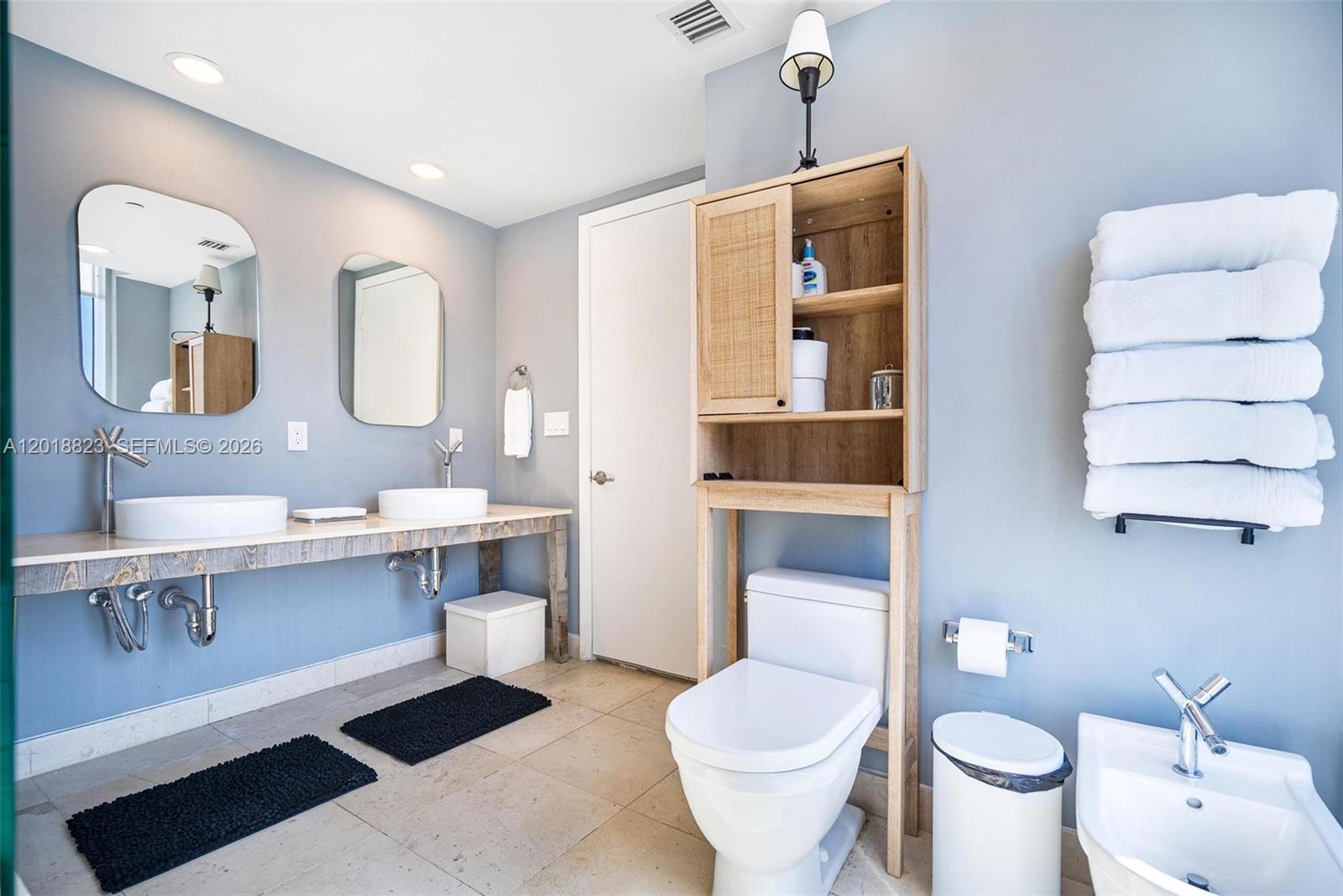 495 Brickell Avenue, Unit 4911 Miami, FL 33131 - Photo 26 of 35 a spacious bathroom with a toilet sink and mirror