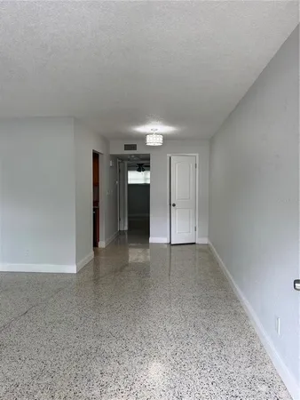 a view of an empty room and a window